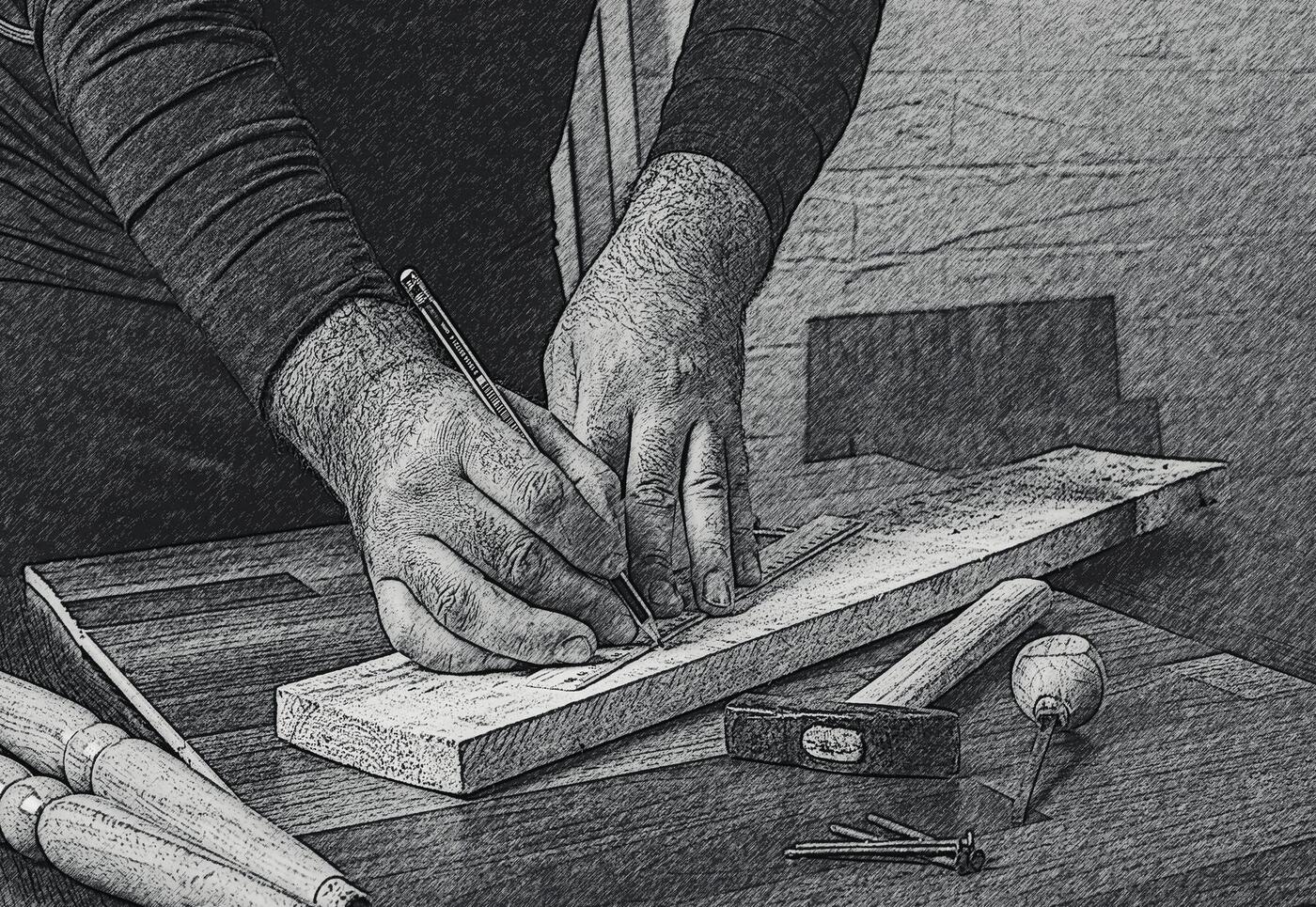 A carpenter marking out timber by hand